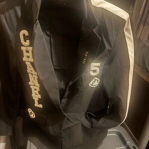 CHANEL Black Blazer with White Shoulder Stripe and Gold Logo Embellishments